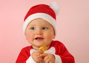 Baby als Weihnachtsmann mit Geschenk